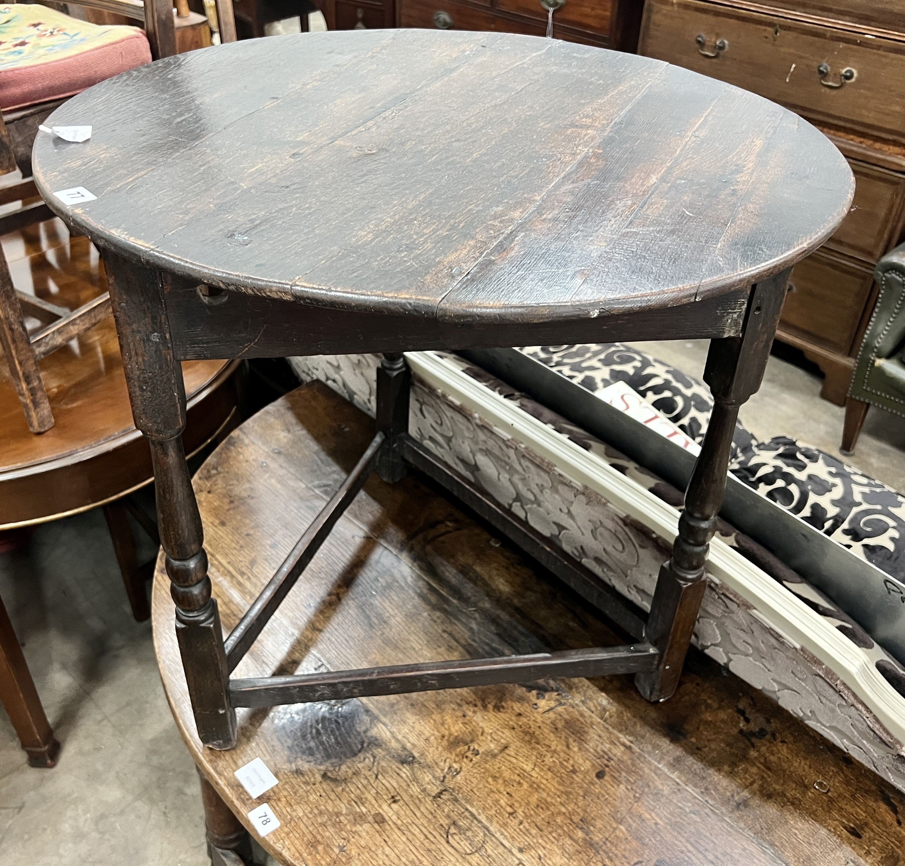 An 18th century circular oak cricket table, diameter 70cm, height 67cm